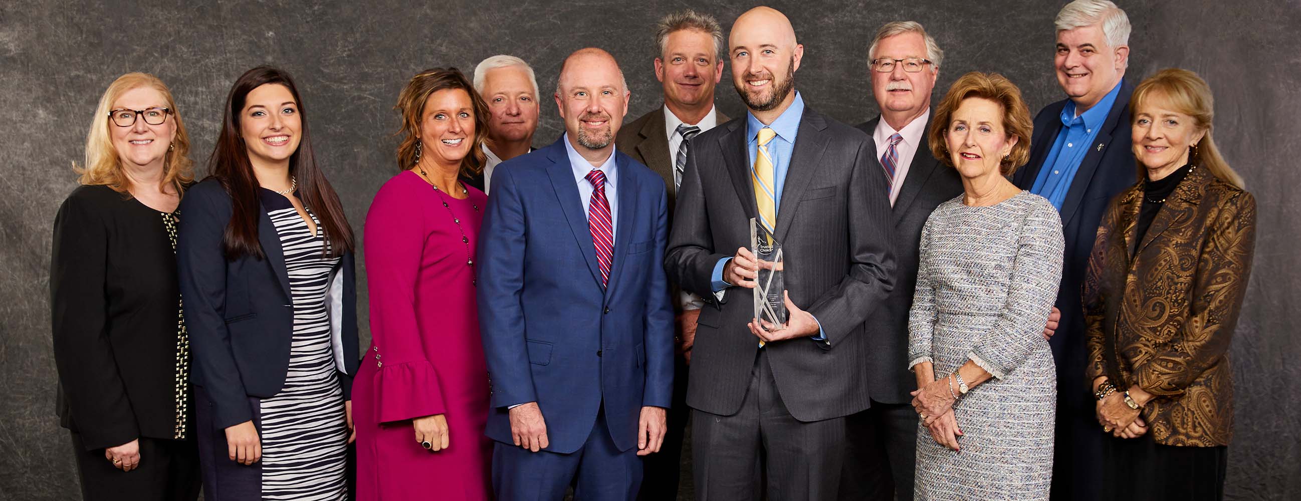 image of patrick roe holidng the IIAY award with other associates