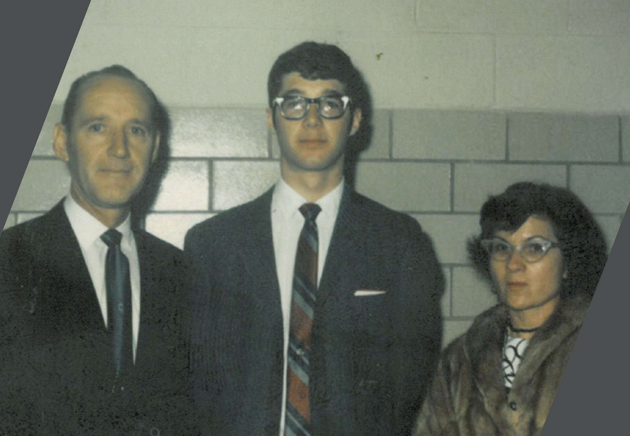 Jim and his parents facing the camera and smiling