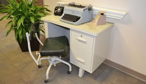 Diagonal view of a desk and typewriter